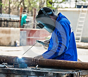 African man worker welding a pipe