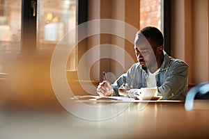 African man working at cafe