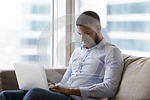 African man working or studying using laptop