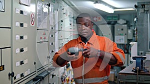 African marine engineer officer in engine control room ECR