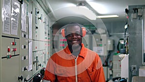 African marine engineer officer in engine control room ECR.
