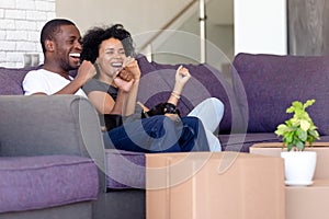 African married couple celebrating relocation at new house