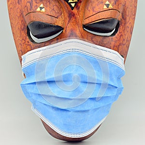 African mask with a surgical mask photo