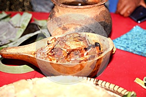 An African meal of roast chicken, pap and soup served on traditional dishes