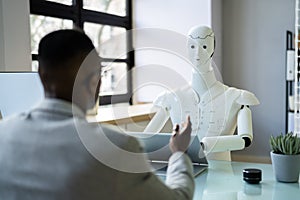 African Men At Interview With AI Robot Machine photo