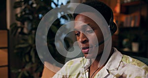 African Mental Health Helpline Operator with a warm smile wears a wireless headset works as mental health helpline