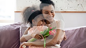African mom hugs daughter express gratitude for attention and flowers