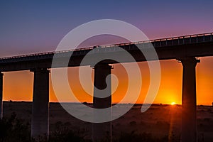 African Morning Magical Sunrise In Nairobi National Park Under Standard Gauge Railway Line Bridge Pillars In Kenya East African