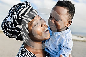 African mother having tender moment with little son outdoor - Love and family concept - Main focus on woman mouth