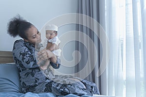 African mother holding The newborn son is 2 months old and is half African