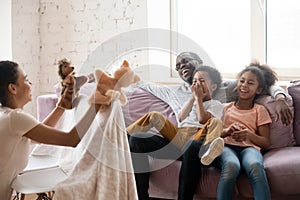 African mother holding puppet toys showing theatrical performance for family