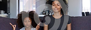 African mother little daughter do meditation practice together at home