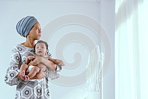 African mother raising a happy baby in the house
