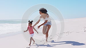 African mother running after her daughter on the beach