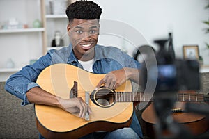 african musician playing guitar photo