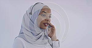 African Muslim customer representative business woman with headset helping and supporting online with customer