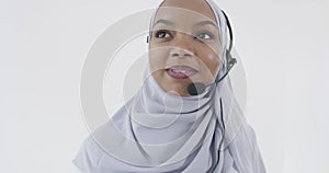 African Muslim customer representative business woman with headset helping and supporting online with customer
