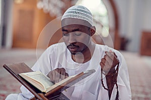 African Muslim Man Making Traditional Prayer To God While Wearing Dishdasha