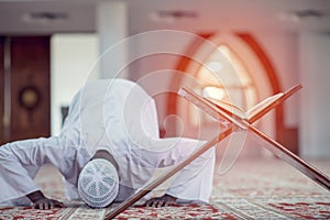 African Muslim Man Making Traditional Prayer To God While Wearing Dishdasha photo