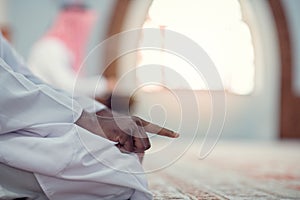 African Muslim Man Making Traditional Prayer To God While Wearing Dishdasha photo