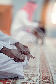 African Muslim Man Making Traditional Prayer To God While Wearing Dishdasha photo