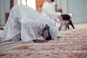 African Muslim Man Making Traditional Prayer To God While Wearing Dishdasha photo