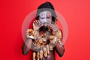 African native man in ethnic wear uses cutlery incorrectly