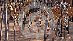 African necklaces shaped like flowers made from seeds and beads on display at an outdoor market in Namibia, Africa. Background out