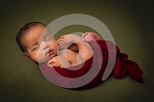 African newborn baby in red wrap