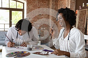 African painter woman with groupmate painting, attend in art class