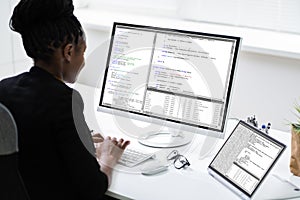 African Programmer Or Coder Using Multiple Monitors