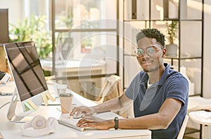 African programmer working at his workplace