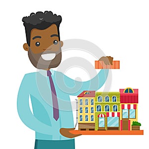 African real estate agent presenting city model.