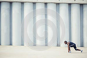 African runner preparing to start on concrete road