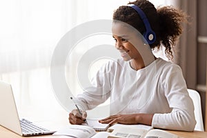 African schoolgirl e-learning using headphones and computer