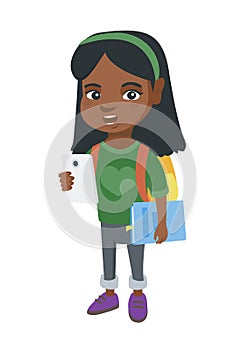 African schoolgirl holding cellphone and textbook