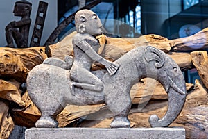 African sculpture of a man riding an elefant made of stone