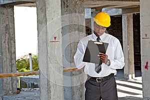 African site inspector surveying construction site