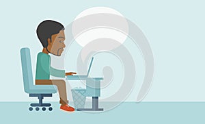 African sitting infront his computer
