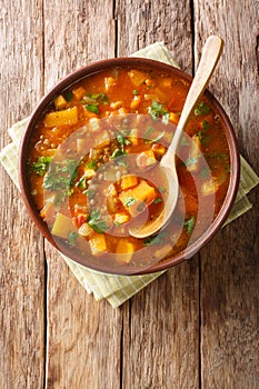 African spicy vegetarian sweet potato with lentil soup close-up in a bowl. Vertical top view