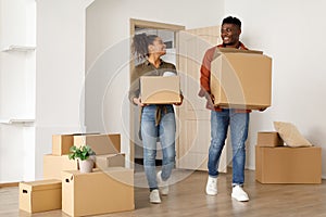 African Spouses Carrying Moving Boxes Entering Their Own House Indoor