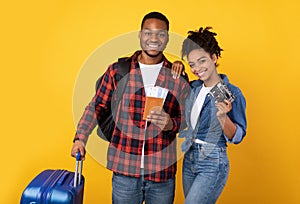 African Spouses Posing With Travel Tickets And Luggage, Yellow Background