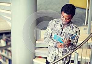 African student boy or man reading book at library