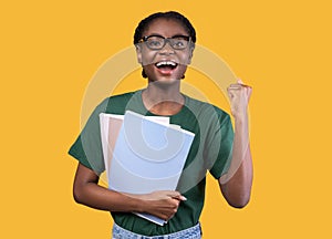 African Student Gesturing Yes After Exam Posing Over Yellow Background