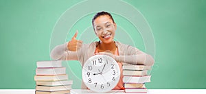 African student girl with books and clock