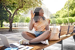 african student girl with coffee, laptop and books