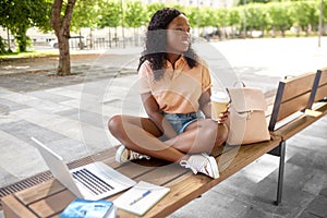 african student girl with coffee, laptop and books