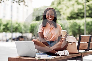 african student girl with coffee, laptop and books