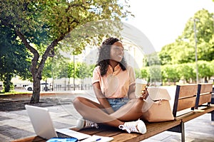 african student girl with coffee, laptop and books