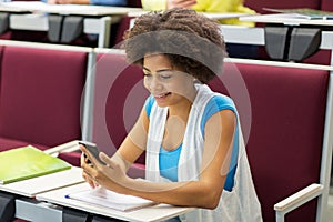 African student girl with smartphone on lecture